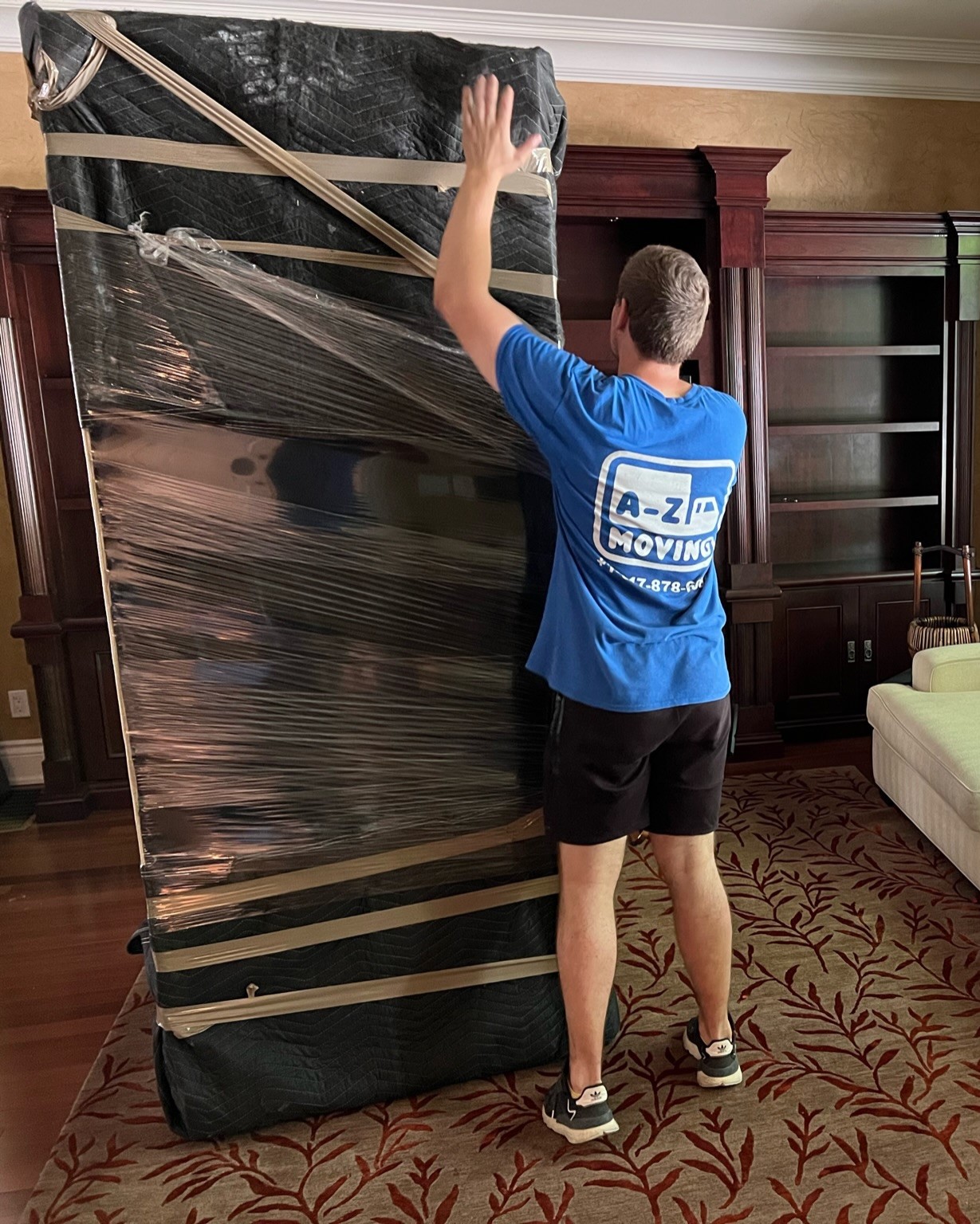 young-delivery-man-using-touchpad-while-reading-label-package 1