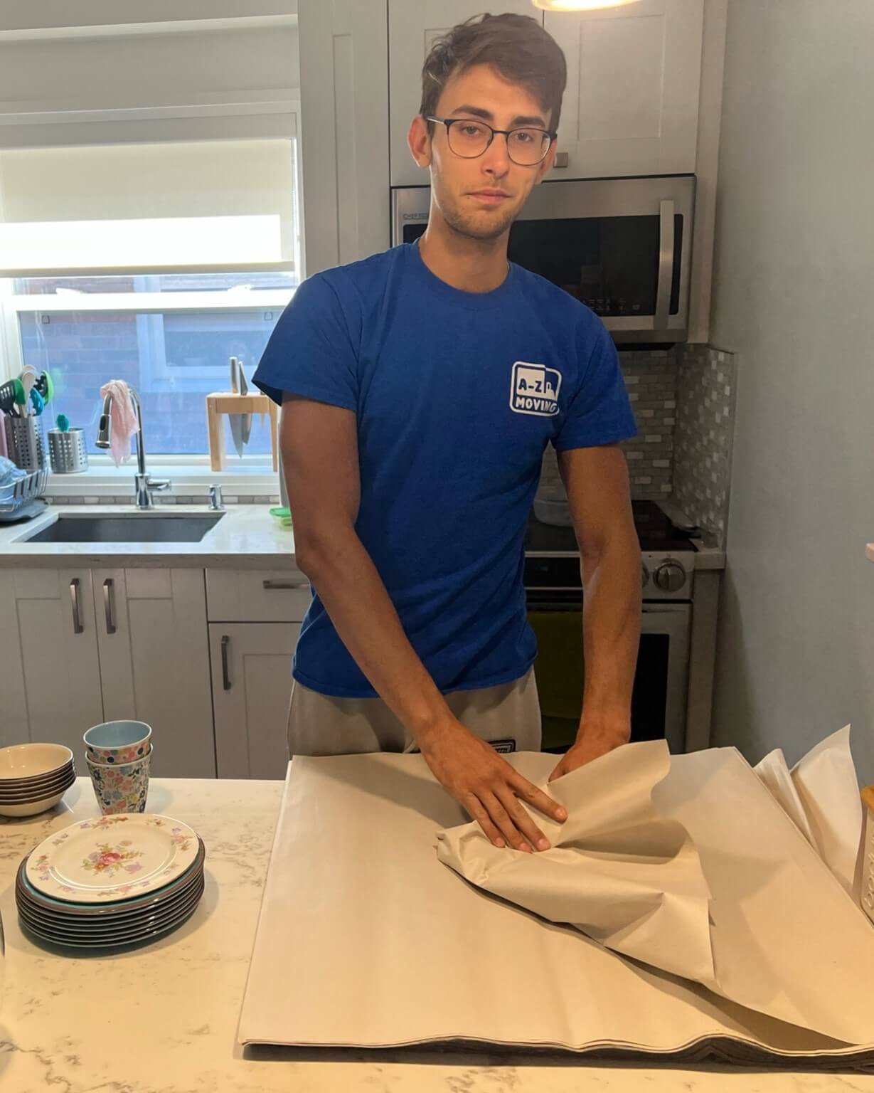 young-delivery-man-using-touchpad-while-reading-label-package 1